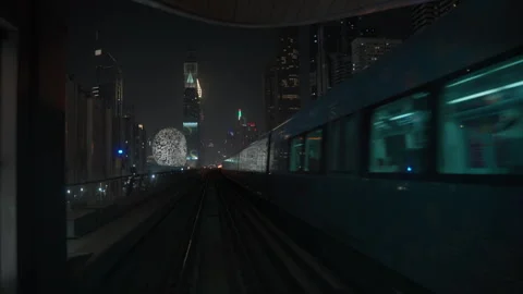 Dubai Metro train passes Museum of the Future in Dubai UAE 库存影片 344935351