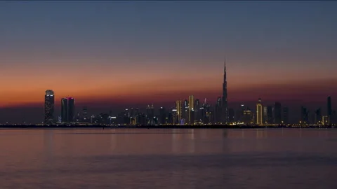 Dubai Skyline silhouette day to night sunset time lapse Stock Footage