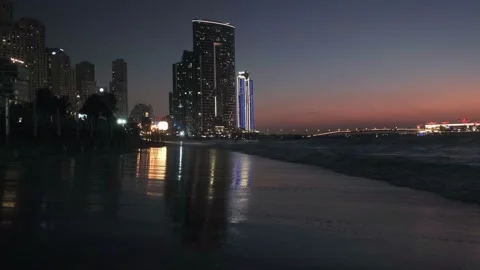 Dubai at sunset, wave beach near the city, dubai city center, dubai skyscraper Stock Footage 234986518