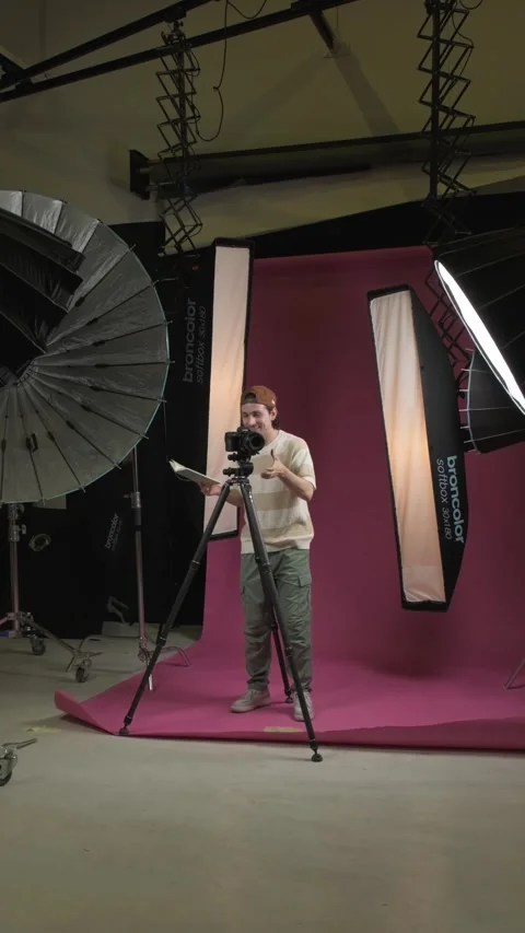 Dubai, UAE - 07 07 2025: Photographer filming on camera tripod in professional Stock Footage 335192214