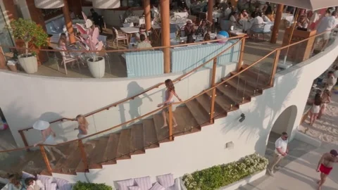 Dubai, UAE - 1 14 2023: The drone flies past the open stairs at the summer cafe Stock Footage 245836912