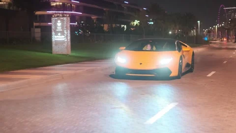 Dubai, UAE - 1 14 2023: Sports premium yellow car on a night street in Dubai Stock Footage 254754228