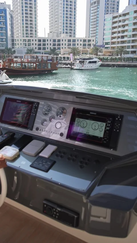 Dubai, UAE - 1 14 2023: Close-up of the captains hands at the helm. He controls Stock Footage 311796586