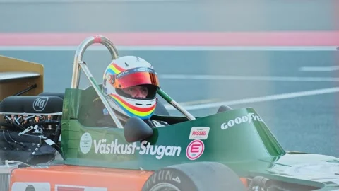 Dubai, UAE - 1 20 2024: Racing car driver wearing a safety helmet inside the Stock Footage 308276576