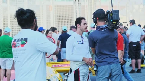 Dubai, UAE - 1 20 2024: A racing car driver is interviewed by a journalist after Stock Footage 308277091