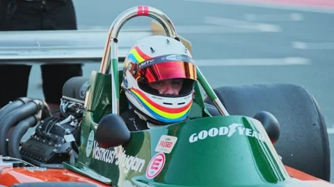 Dubai, UAE - 1 20 2024: Racing car driver wearing a safety helmet inside the Stock Footage 310724709