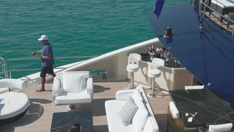 Dubai, UAE - 3 20 2023: A drone flies around a yacht sailing on the sea on a Stock Footage 246735608