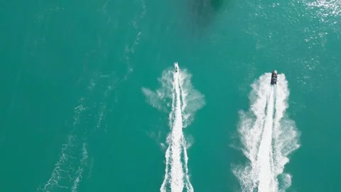 Dubai, UAE - 3 20 2023: A drone flies over people riding jet skis on the sea Stock Footage 248233349