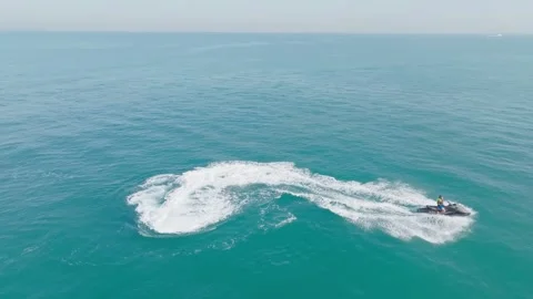 Dubai, UAE - 3 20 2023: A drone flies over people riding jet skis in the sea Stock Footage 255721791