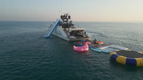 Dubai, UAE - 3 20 2023: A drone flies around a luxury private yacht standing in Stock Footage 258025137