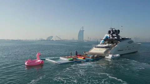 Dubai, UAE - 3 20 2023: A drone flies around a luxury private yacht standing in Stock Footage 270218002