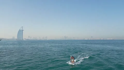 Dubai, UAE - 3 20 2023: A drone flies over people riding jet skis and an Stock Footage 339752740