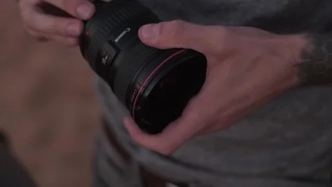 Dubai, UAE - 4 11 2018: The photographer replaces the lens on the camera Stock Footage 246205000