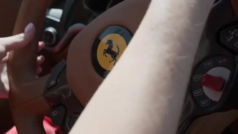 Dubai, UAE - 4 11 2018: Young woman holding on to the steering wheel of an Stock Footage 254869052