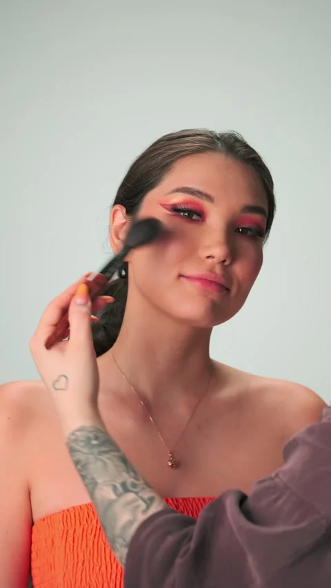 Dubai, UAE - 7 10 2023: The master makes professional makeup for a young woman Video stock 310434725
