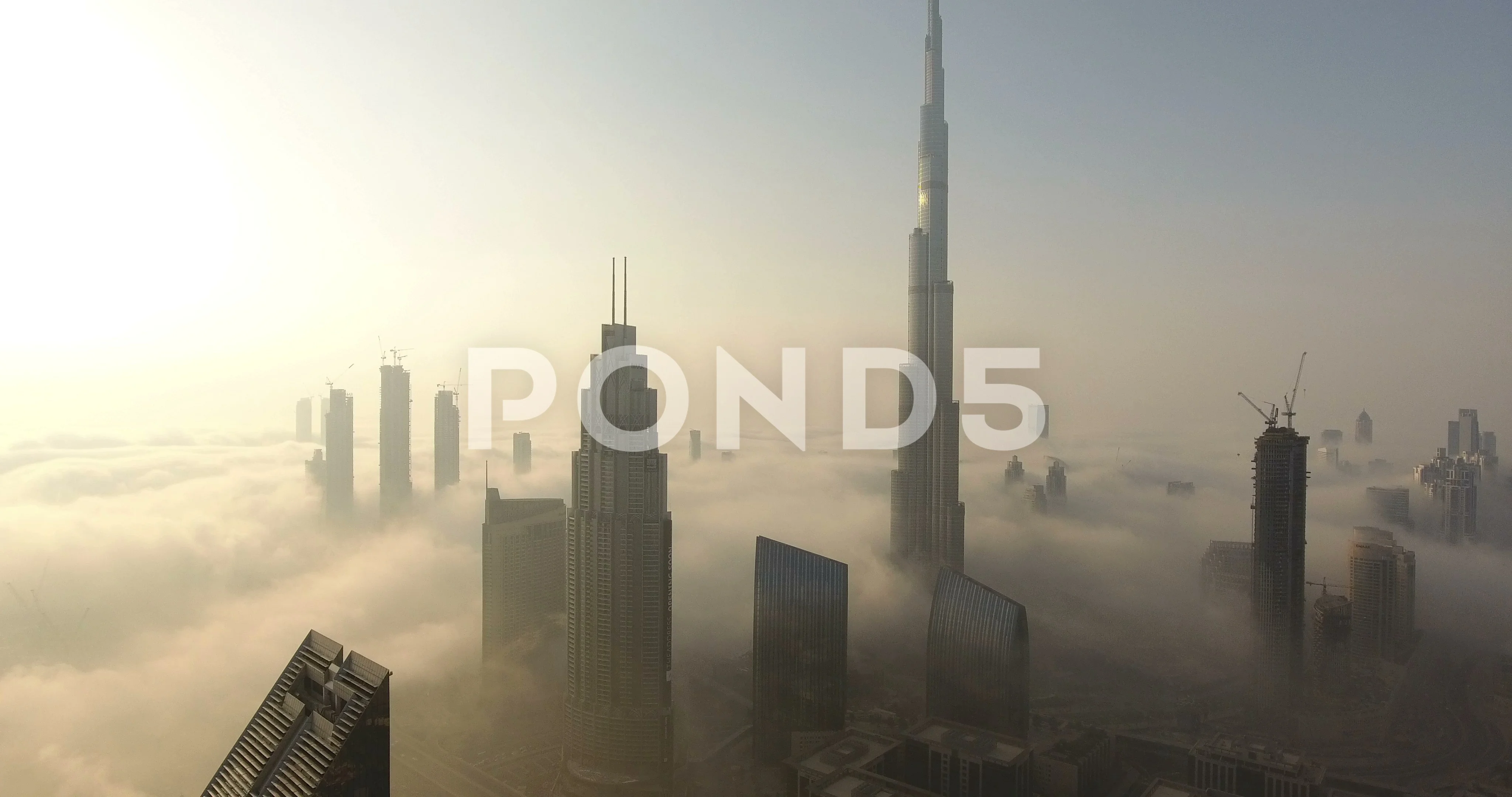 Premium AI Image  Cinematic shot of Burj Khalifa with clouds fog