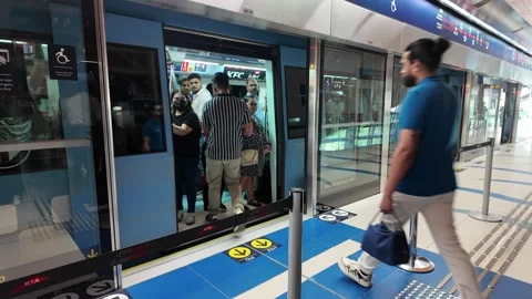 DUBAI, UAE - APRIL 15, 2026: Commuters and tourists using the Dubai Metro a.. Stock Footage 332770872