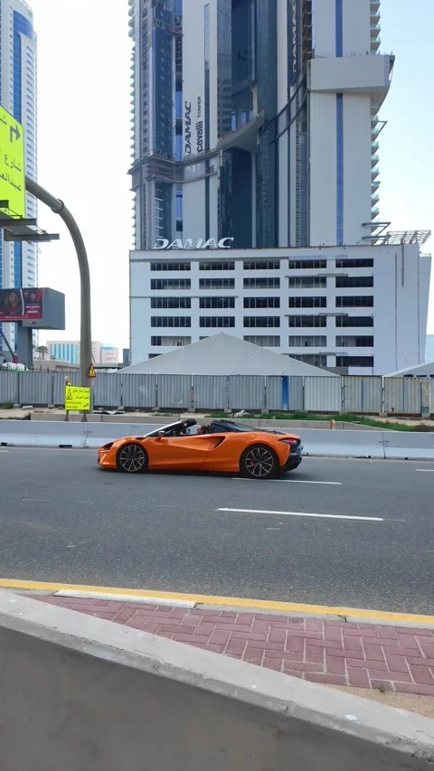 DUBAI, UAE - APRIL 16, 2026: Luxury supercars and high-end SUVs driving on .. Stock Footage 332835577