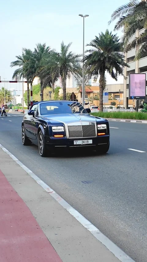 DUBAI, UAE - APRIL 16, 2026: Luxury supercars and high-end SUVs driving on .. Stock Footage 332835592