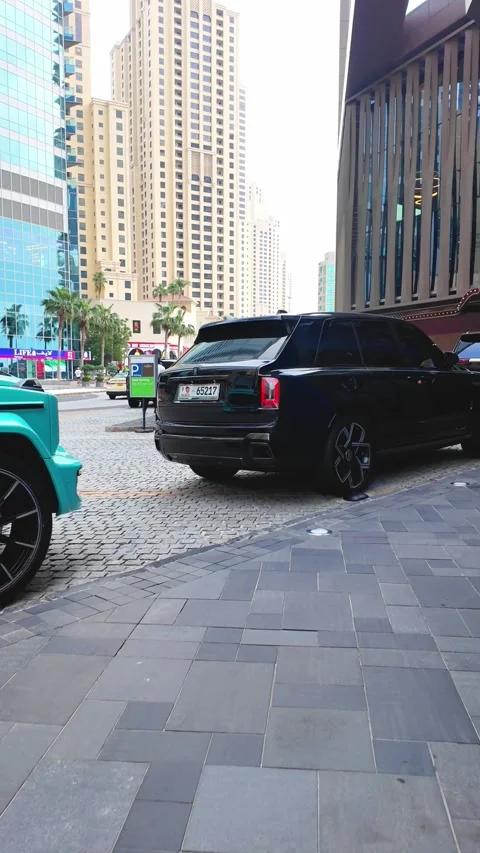 DUBAI, UAE - APRIL 16, 2026: Luxury supercars and high-end SUVs driving on .. Stock Footage 332835601
