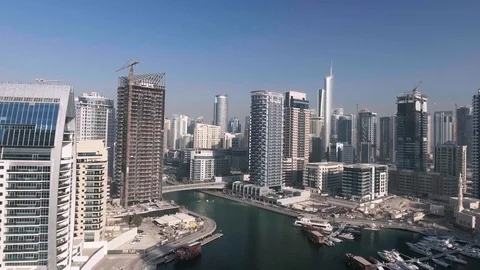 DUBAI, UAE - DECEMBER 2016: Flying in the middle of Dubai Marina skyscrapers, Stock Footage 101897782