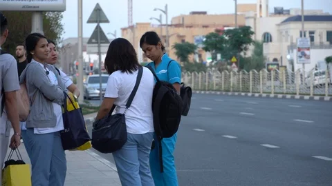 Dubai UAE - December 2019: Group of young women waiting the tram, bus. Stylis Stock Footage 120675642