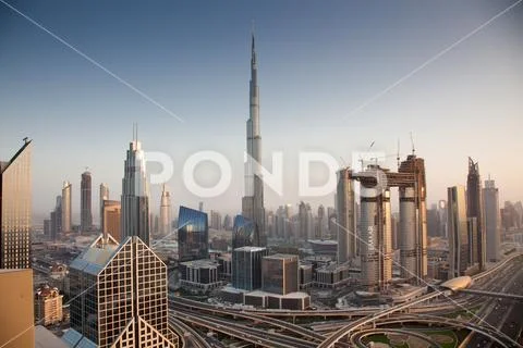 DUBAI, UAE - FEBRUARY 2018: Dubai skyline at sunset with Burj Khalifa, the wo Stock Photos