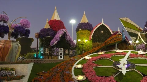 Dubai, UAE - January 18, 2018: art sculpture fairy houses and large clock dial Stock Footage 86174656