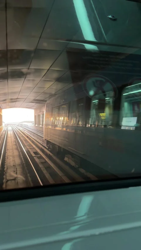 Dubai UAE July 7 2026 Sunset view from Dubai Metro overlooking city skyline Stock Footage 338391214