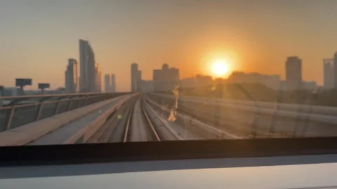 Dubai UAE July 7 2026 Sunset view from Dubai Metro overlooking city skyline Stock Footage 338391428