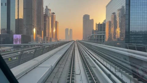 Dubai UAE July 7 2026 Sunset view from Dubai Metro overlooking city skyline Stock Footage 338391435
