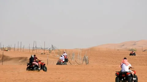 Dubai, UAE - June 02, 2024: Tourists riding ATV in the desert in Dubai. Stock Footage 279878468