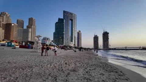 Dubai, UAE - June 02, 2026: Tourists and locals enjoying a sunset walk at J.. Stock Footage 336175470