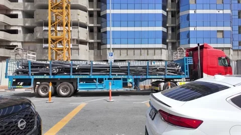 Dubai, UAE - June 11, 2026: Industrial truck transporting steel rebar at a .. Stock Footage 336714003