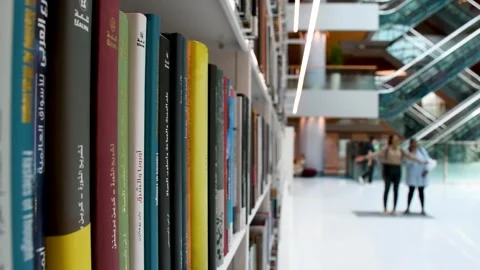 Dubai, UAE - June 19, 2024: Close-up of books on shelves in the Library. Stock Footage 279877509