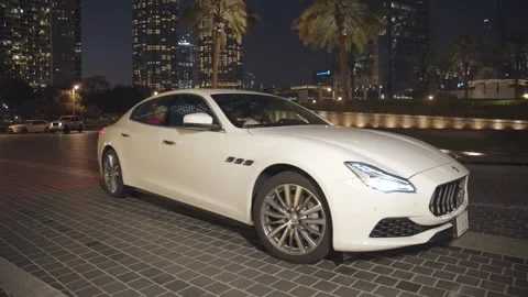 DUBAI, UAE - MARCH 7, 2020: Victoria Lopyreva and husband drive up to Maserati Stock Footage 133432000