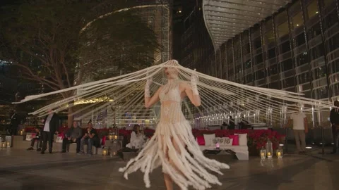 DUBAI, UAE - MARCH 7, 2020: Girl in a costume of pearls and white feathers whirl Stock Footage 134898730