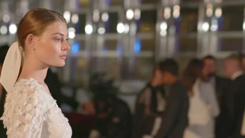 DUBAI, UAE - MARCH 7, 2020: Models in white suits pose for fashion show Stock Footage 134899056