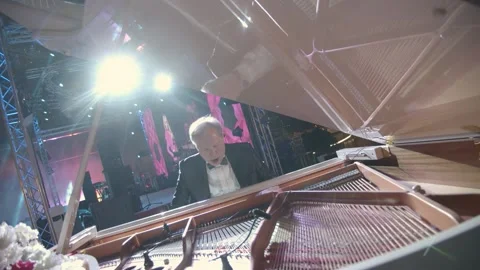 DUBAI, UAE - MARCH 7, 2020: Pianist virtuoso Yury Rozum plays white grand piano Stock Footage 134899247