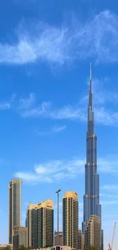 Dubai, UAE - May 01.2018: Horizontal clouds in a blue sky over tall buildings, Fotos de archivo