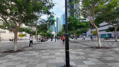 DUBAI, UAE - MAY 13, 2026: People and workers walking in a public area and .. Stock Footage 334768118