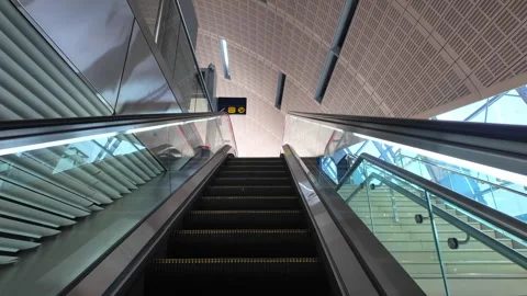 DUBAI, UAE - MAY 13, 2026: People using Dubai Metro escalator, interior com.. Stock Footage 334769917