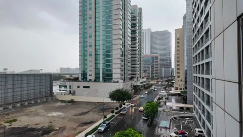 DUBAI, UAE - MAY 14, 2026: Heavy rain falling over city streets and skyscra.. Stock Footage 334875599