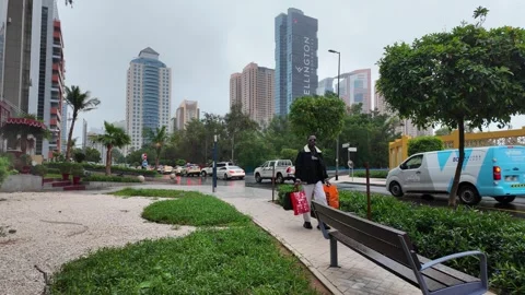 DUBAI, UAE - MAY 14, 2026: Heavy rain falling over city streets and skyscra.. Stock Footage 334876964
