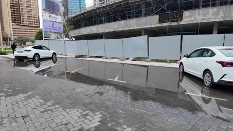 DUBAI, UAE - MAY 14, 2026: Municipal workers using water tankers and pumps .. Stock Footage 334921309