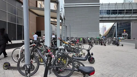DUBAI, UAE - MAY 15, 2026: People walking and cycling in the modern urban d.. Stock Footage 334922310