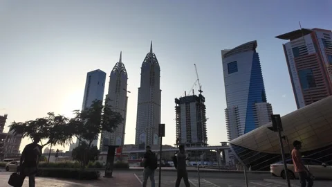 DUBAI, UAE - MAY 15, 2026: People walking and cycling in the modern urban d.. Stock Footage 334922320
