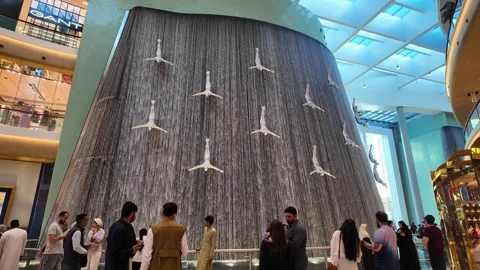 DUBAI, UAE - MAY 16, 2026: Cinematic shot of the indoor waterfall inside Du.. Stock Footage 335022062