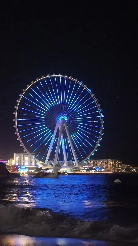 Dubai, UAE - May 24, 2026: Ain Dubai Ferris wheel illuminated at night, Blu.. Stock Footage 335550220