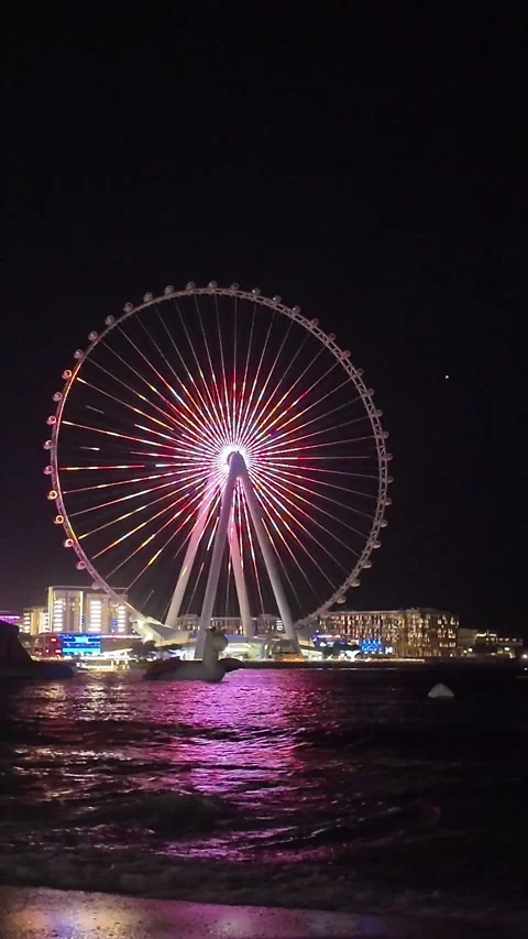 Dubai, UAE - May 24, 2026: Ain Dubai Ferris wheel illuminated at night, Blu.. Stock Footage 335550331